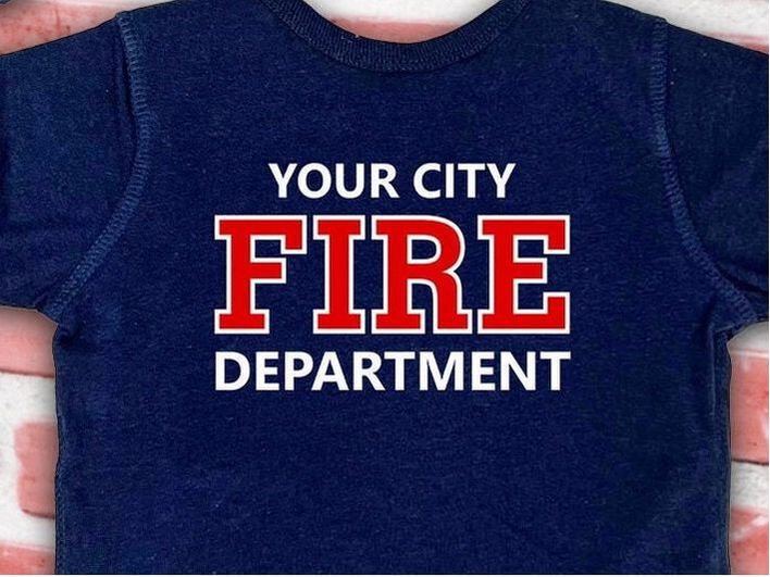 Back view of the baby bodysuit displaying custom fire department name with 'Fire' and 'Department' text in red on navy blue fabric
