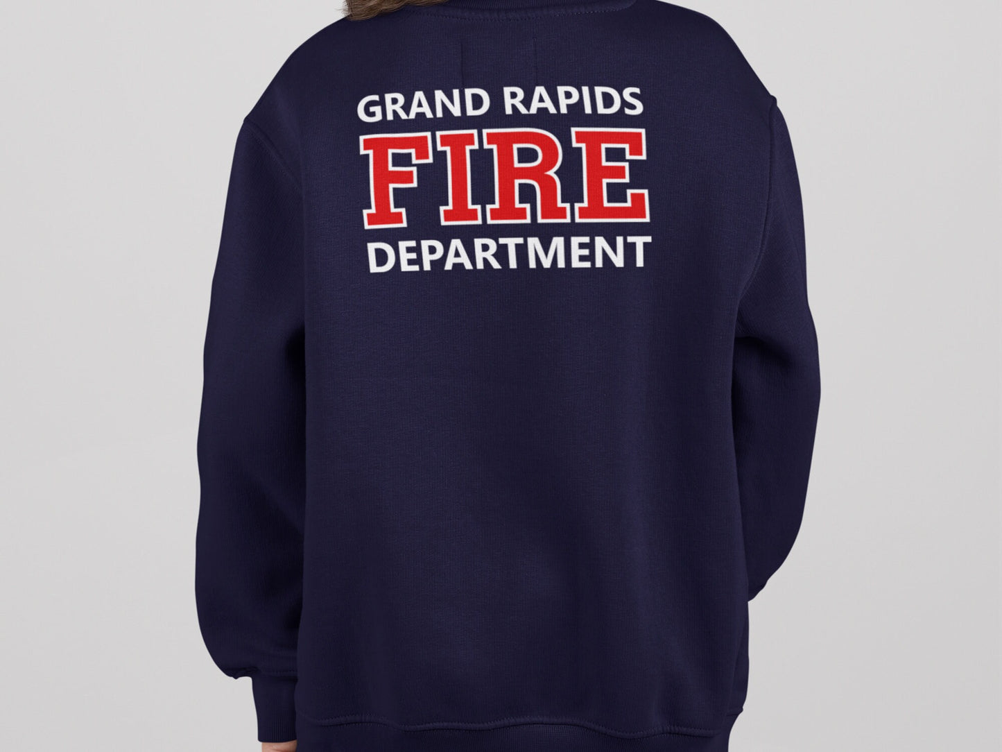 Back view of long sleeve navy blue sweatshirt with 'Grand Rapids Fire Department' in red and white text.