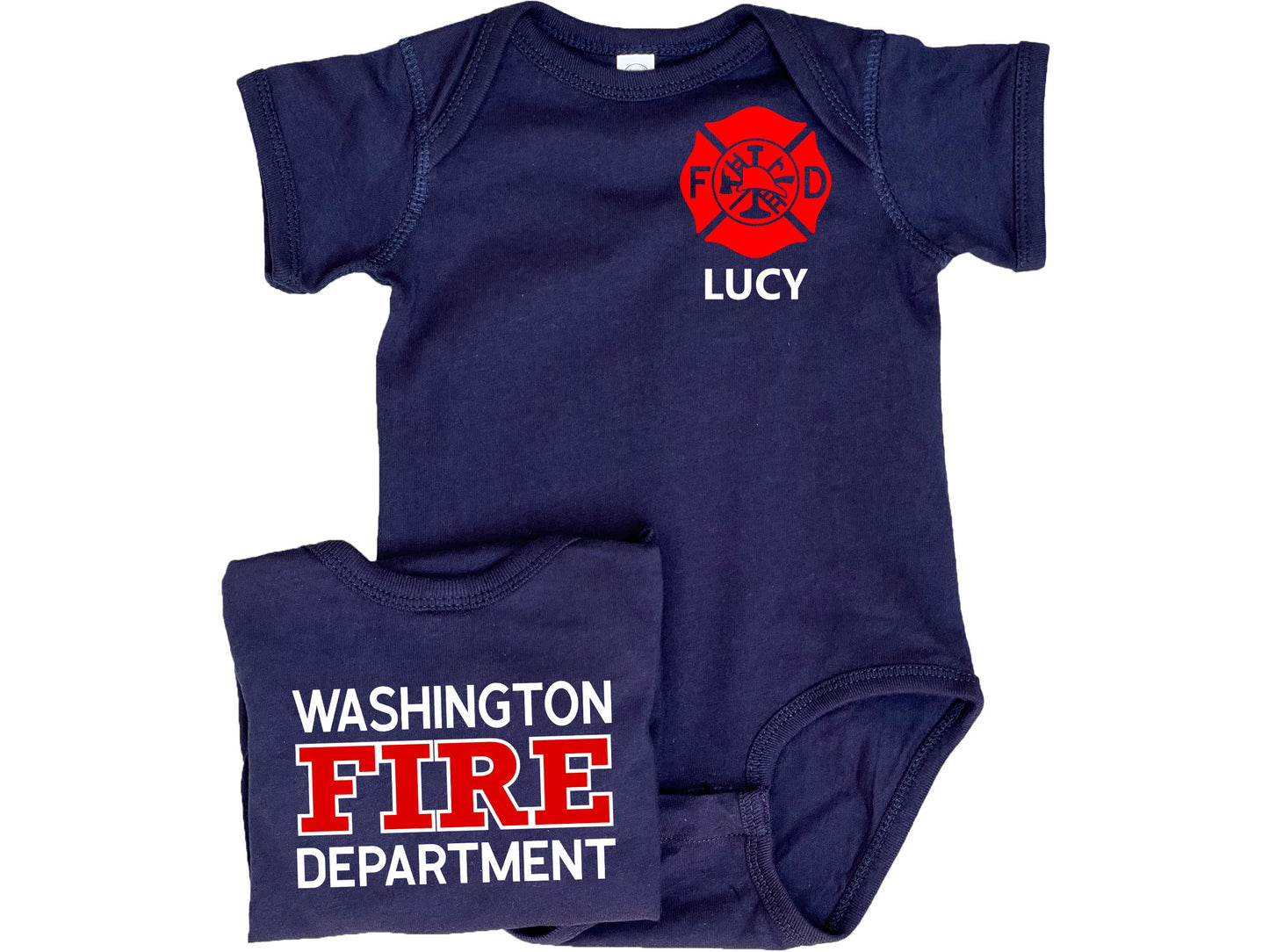 Navy blue short sleeve baby bodysuit with custom red Maltese Cross on the front. The child's name is under the Maltese Cross. A folded bodysuit shows the back with a custom fire department name with "Fire" and "Department" written underneath. The bodysuit is legless and has snaps at the crotch.