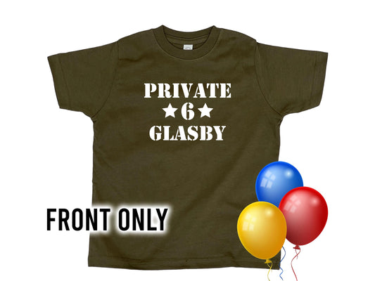 Army green t-shirt with 'Private' in white text on the top line, 2 stars and the number 6 underneath, and under that 'Glasby' in white text. 3 colorful balloons for a birthday theme.