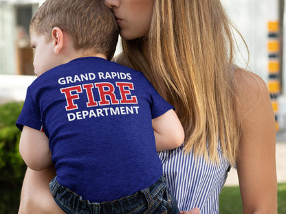 Close-up of the back of the toddler&#39;s bodysuit featuring the custom fire department name in red text on navy blue fabric