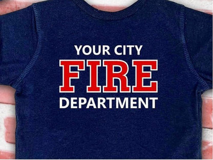 Back view of the baby bodysuit displaying custom fire department name with &#39;Fire&#39; and &#39;Department&#39; text in red on navy blue fabric