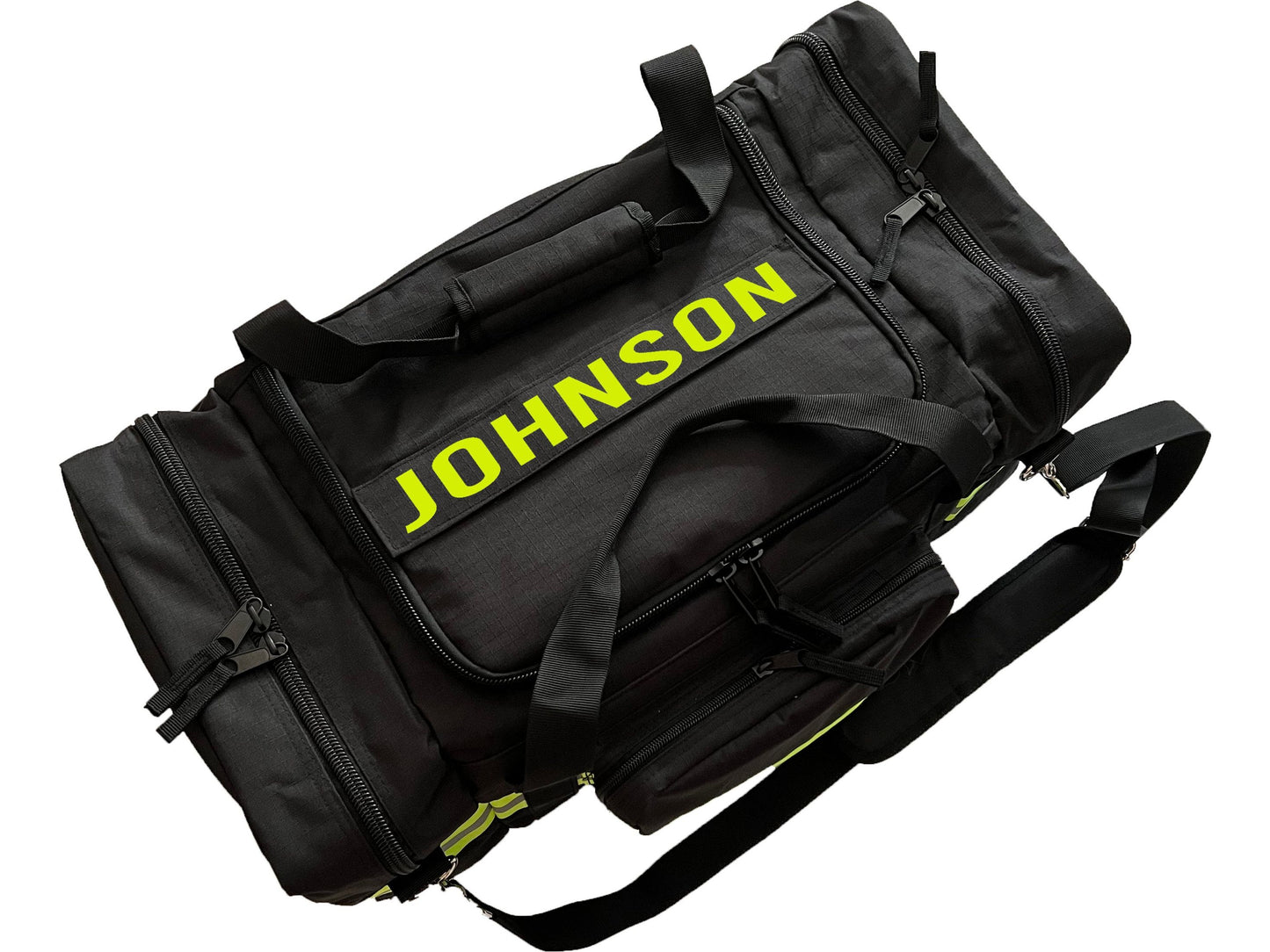 To view of black firefighter duffel bag with yellow text “Johnson” indicating the place for personalization.