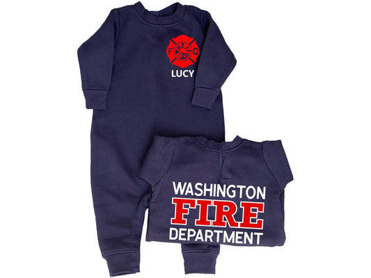 Navy blue long sleeve, long leg fleece bodysuit in baby sizes with custom red Maltese Cross on the front. The baby&#39;s name is under the Maltese Cross. A folded bodysuit shows the back side with a custom fire department name with &quot;Fire&quot; and &quot;Department&quot; underneath. The bodysuit has snaps at the back of the neck and up both legs.