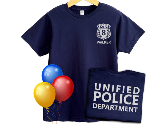 Navy blue t-shirt with silver police badge on left chest with the number 8 and the name &#39;WALKER&#39; underneath in silver text. The shirt back has the text &#39;UNIFIED POLICE DEPARTMENT&#39; in silver text.