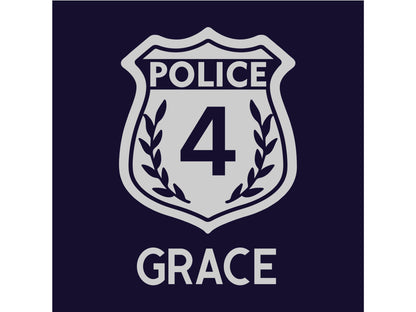 Close up detail of silver police badge containing the number &#39;4&#39; and the name &#39;Grace&#39; underneath on a navy blue background.