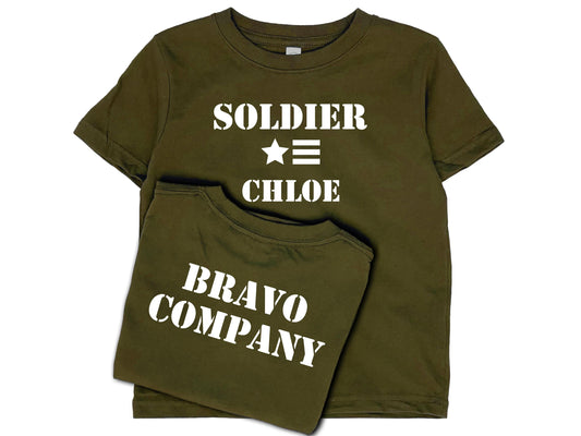 Army green short sleeve t-shirt with &#39;Soldier&#39; in white text, a star and 3 horizontal stripes underneath, and under that the name &#39;Chloe&#39;. The shirt back reads &#39;Bravo Company&#39; in white text.