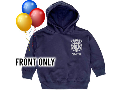 Navy blue hoodie with silver police badge that contains the number &#39;3&#39; as a placeholder for child&#39;s age. The name &#39;Smith&#39; is underneath also as a placeholder for the child&#39;s name.
