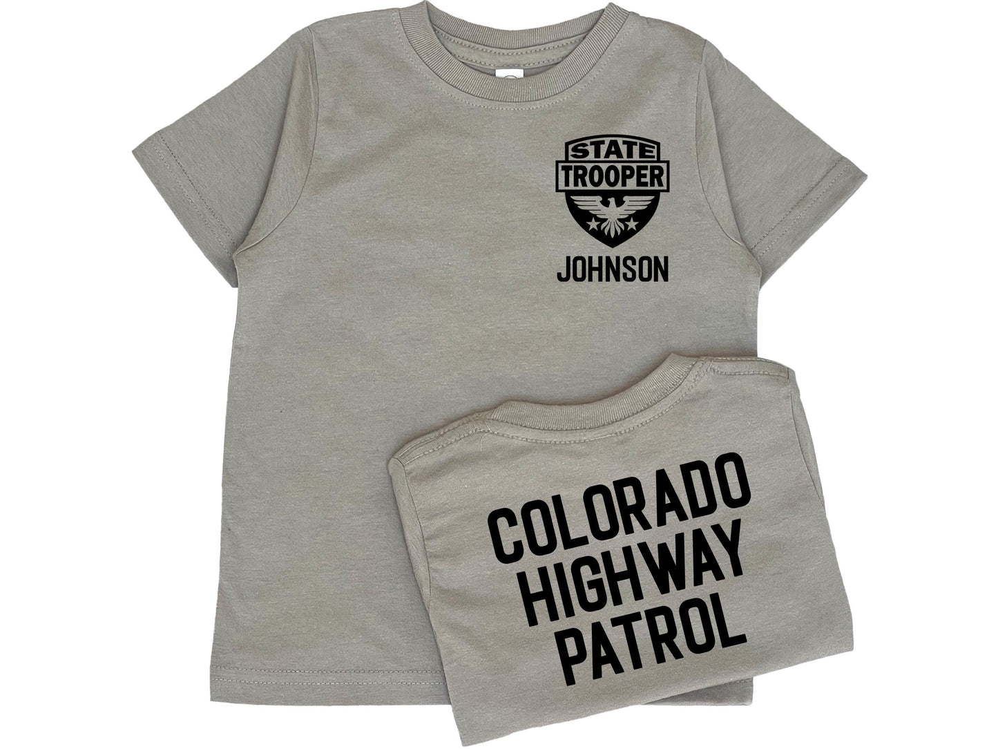Gray toddler t-shirt with black State Trooper Badge with an eagle on the front left chest. Under the badge is &#39;Johnson&#39; as a placeholder for custom name. The shirt back has black text &#39;Colorado Highway Patrol&#39; also a placeholder for custom text.