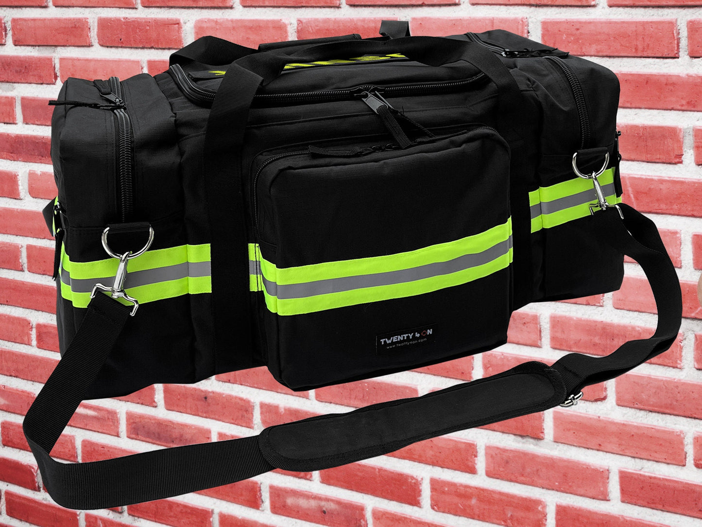 Black gym bag with fluorescent lime yellow reflective tape. Bag has zippered main compartments with two zippered pockets, one on each end. Shoulder strap and hand held handle.